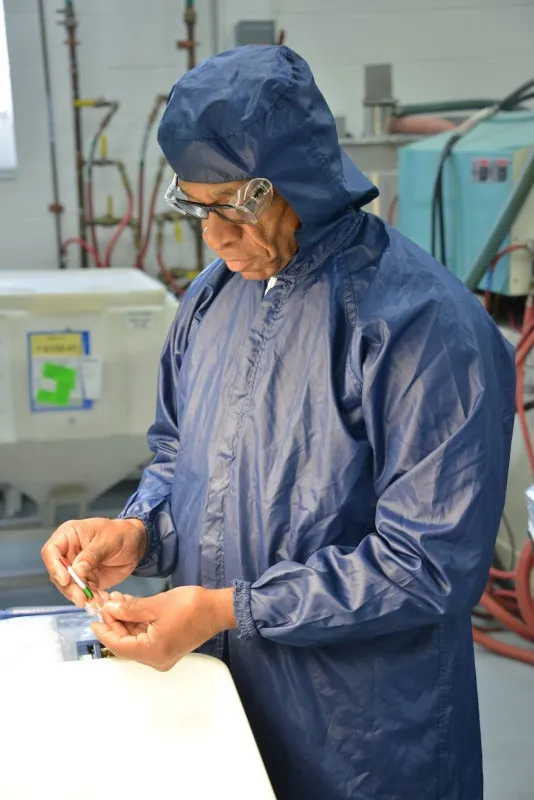 employee in sharp concentration working with vial